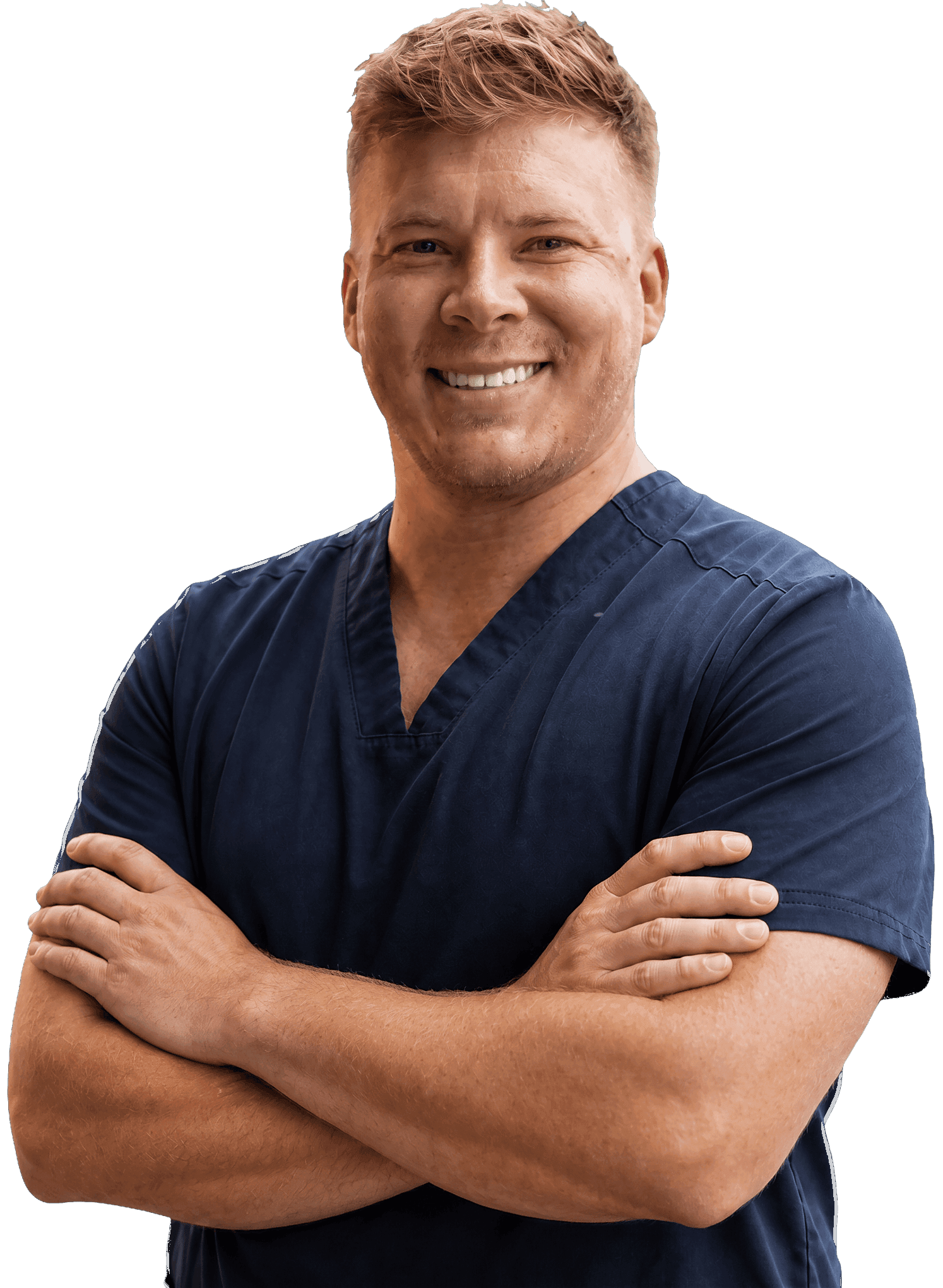 Dr. Kyle McDonald in navy scrubs, smiling with his arms crossed.